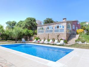a swimming pool in front of a house at Holiday Home Cris by Interhome in Mont Barbat