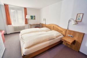 a bedroom with a bed with a wooden head board at Gästehaus Korf in Unkel +23 photos