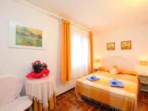 a bedroom with a bed and a table with towels at Holiday Home Puig Dels Daus by Interhome in Calonge