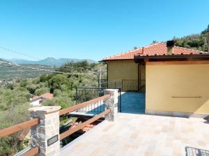 a balcony with a view of a house at Apartment A Ca' Gialla - AEG100 by Interhome in Villanova dʼAlbenga