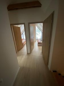an empty room with two doors and a living room at Chata Večernica in Liptovský Mikuláš