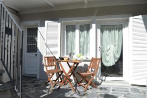 a patio with two chairs and a table on a porch at Casa della Rosina in Stresa