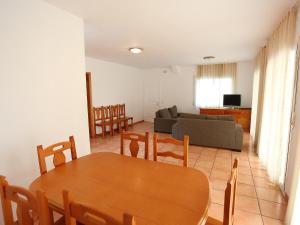 a living room with a table and chairs and a couch at Villa Villa Cala Nova B by Interhome in Les tres Cales