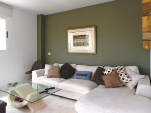 a living room with a white couch and a glass table at Apartment Arenal-1 by Interhome in Jávea