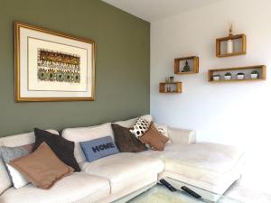 a living room with a white couch with pillows at Apartment Arenal-1 by Interhome in Jávea