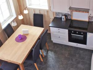 a kitchen with a wooden table with a purple bowl on it at Holiday Home Blåbærhytta by Interhome in Onarheim