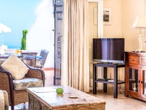 a living room with a tv and a couch at Holiday Home Tejon by Interhome in Nerja
