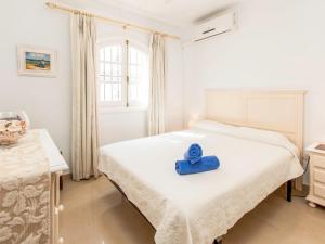 a room with a bed with a blue towel on it at Holiday Home Tejon by Interhome in Nerja