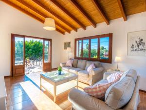 a living room with couches and a table at Villa Es Trenc Pool-Beach House Xaloc 99 by Interhome in Sa Ràpita