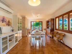 a kitchen and dining room with a table and chairs at Villa Es Trenc Pool-Beach House Xaloc 99 by Interhome in Sa Ràpita +39 photos