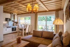 a living room with a couch and a dining room at Landhaus Laih in Grafenau