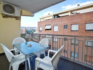 a balcony with a table and chairs and a building at Apartment Gabriel by Interhome in Calpe