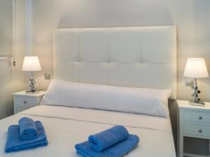 a white bed with two blue towels on it at Apartment Reserva de Marbella by Interhome in Marbella +21 photos