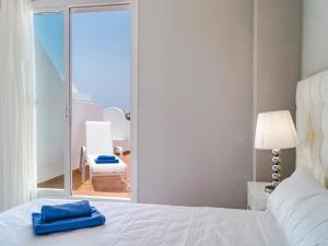 a bedroom with a bed and a view of a chair at Apartment Reserva de Marbella by Interhome in Marbella