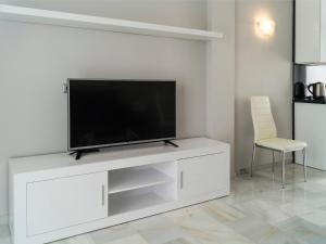 a white entertainment center with a flat screen tv on it at Apartment Reserva de Marbella by Interhome in Marbella