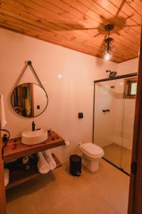 a bathroom with a sink and a toilet and a mirror at La Nostra Terra in Nova Veneza