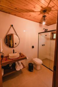 a bathroom with a sink and a toilet and a mirror at La Nostra Terra in Nova Veneza +29 photos