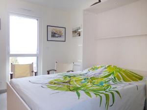 a bedroom with a bed with a painting on it at Studio Les Allées du Port by Interhome in Saint Malo