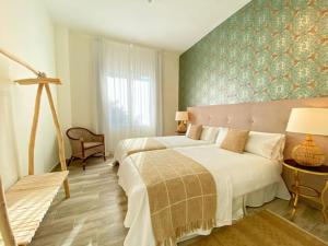 A bed or beds in a room at iloftmalaga Plaza Marina