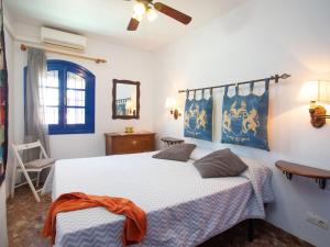 a bedroom with a bed and a ceiling fan at Holiday Home Nerja Penthouse by Interhome in Nerja