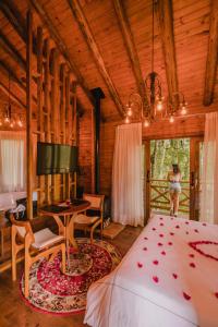 a woman standing in a bedroom with a bed and a desk at La Nostra Terra in Nova Veneza