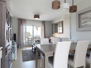 a dining room with a table and white chairs at Apartment Marina Park-1 by Interhome in Denia