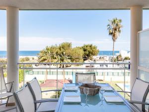 a blue table with chairs and a view of the ocean at Apartment Marina Park-1 by Interhome in Denia