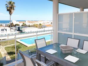 a balcony with a table and chairs and a swimming pool at Apartment Marina Park-1 by Interhome in Denia +11 photos