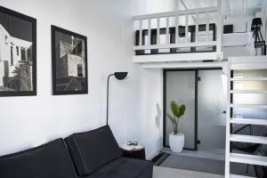 a living room with a couch and a loft bed at Almyra Guest Houses in Paraga
