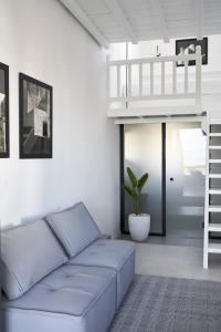 a living room with a couch and a loft bed at Almyra Guest Houses in Paraga