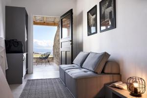 a living room with a couch and a view of the ocean at Almyra Guest Houses in Paraga