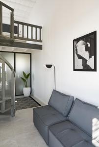 a living room with a couch and a loft bed at Almyra Guest Houses in Paraga