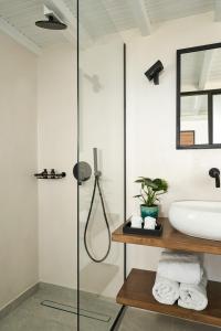 a bathroom with a shower and a sink at Almyra Guest Houses in Paraga