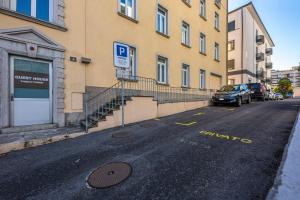 
a car parked on the side of a road near a building at Lugano Center GuestHouse in Lugano
