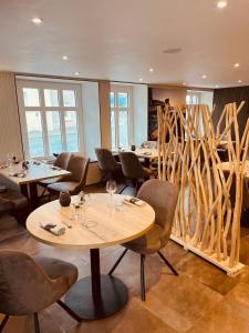 a restaurant with tables and chairs and a wooden fence at Hotel Restaurant de la Marne in Paimpol
