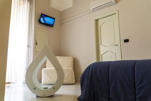 a room with a bed and a sign on the floor at A Casa di Nonna Ada in Manduria