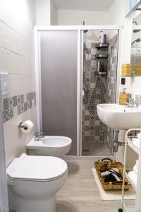 a bathroom with a toilet and a sink and a shower at A Casa di Nonna Ada in Manduria +6 photos