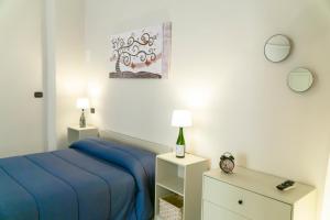 a bedroom with a blue bed and two night stands at A Casa di Nonna Ada in Manduria