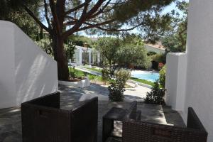 a patio with a table and chairs and a pool at Hotel Misty in Cadaqués