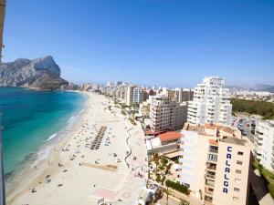 a view of a beach with people and the ocean at Apartment Esmeralda 02 by Interhome in Calpe