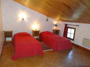 ルシヨンにあるHoliday Home Josette by Interhomeの赤いカバーのベッド2台が備わる客室です。