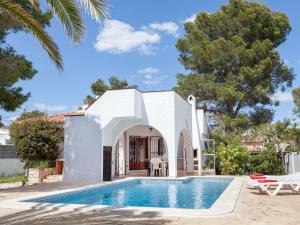 a villa with a swimming pool in front of a house at Villa Villa Zozo by Interhome in L'Ametlla de Mar
