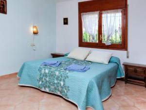 a bedroom with a bed with a window at Villa Villa Zozo by Interhome in L'Ametlla de Mar