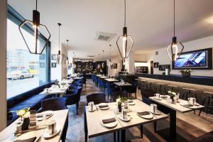 a restaurant with tables and chairs and a large window at LINDEMANN'S in Berlin
