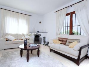 a living room with two white couches and a table at Villa Arcada by Interhome in Miami Platja