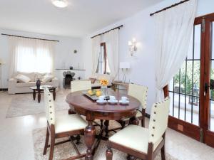 a dining room with a wooden table and chairs at Villa Arcada by Interhome in Miami Platja