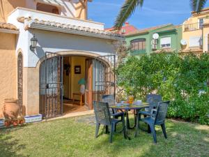 a patio with a table and chairs in front of a house at Holiday Home El Arenal by Interhome in Jávea