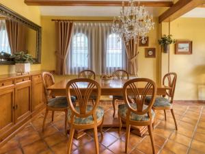 a dining room with a wooden table and chairs at Holiday Home El Arenal by Interhome in Jávea +29 photos