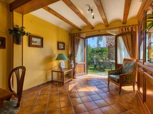 a living room with yellow walls and a table and chairs at Holiday Home El Arenal by Interhome in Jávea
