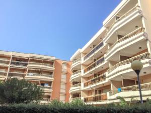 an apartment building with balconies on the side of it at Apartment Les Platanes-4 by Interhome in Sainte-Maxime
